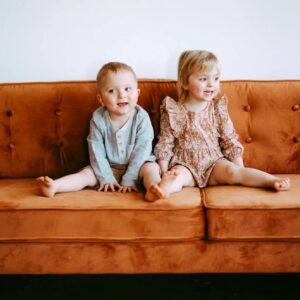 Emerson and Brooklynn sitting on couch