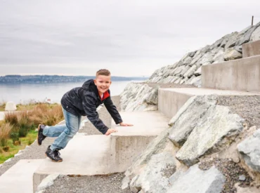 Ryker climbing a staircase by the water