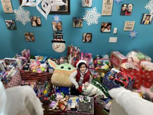child sitting with donated toys