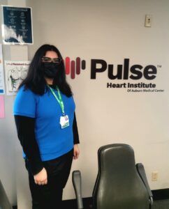 Nazaha in front of Pulse Heart Institute sign