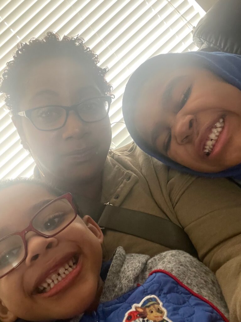 boys taking selfie with mom